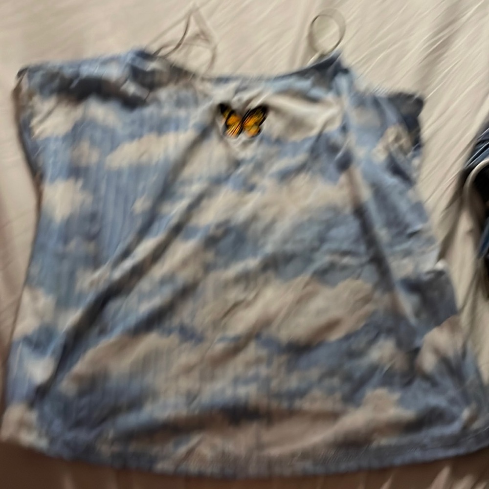 White and blue tiedyed shirt with butterfly on it